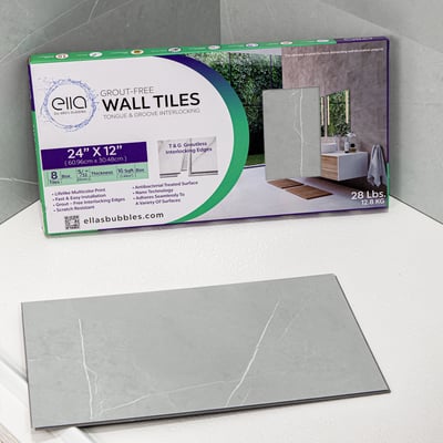 Ella's Bubbles grout-free wall tile box with a single Carrara Iris 24x12 inch sample tile displayed in front