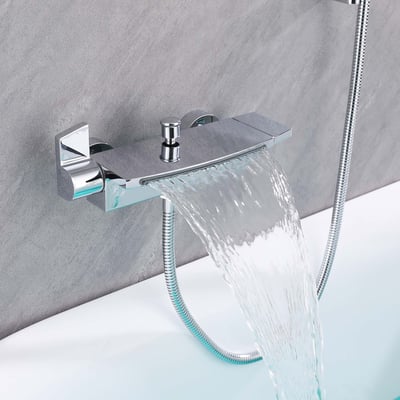 Close-up of a chrome wall-mounted waterfall faucet filling a walk-in tub with a flexible handheld shower hose