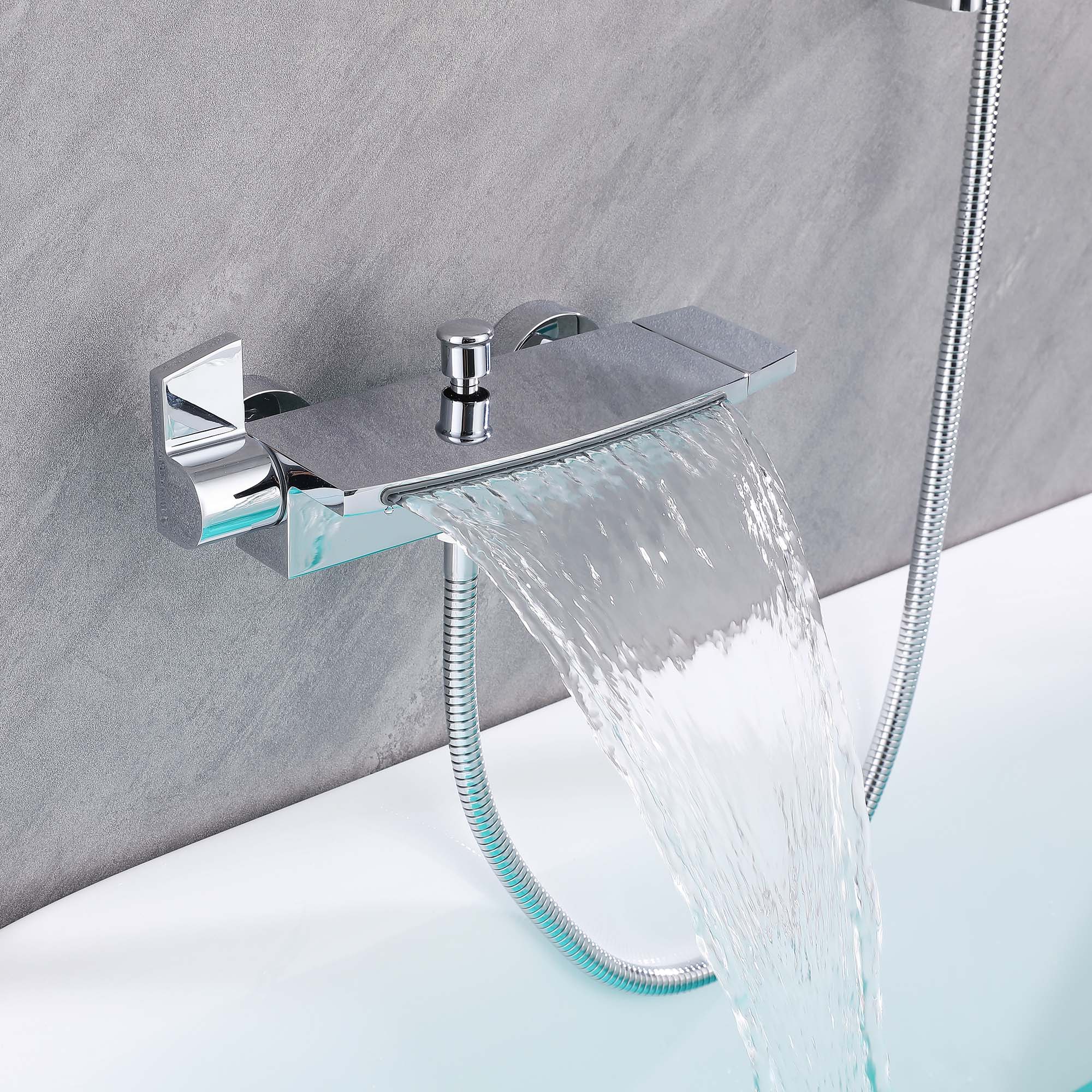 Chrome waterfall tub filler faucet with wide cascading water flow and flexible hand shower hose mounted on a walk-in tub wall