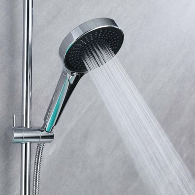 Chrome handheld showerhead on adjustable slide bar spraying a wide rain-pattern water stream in a walk-in shower