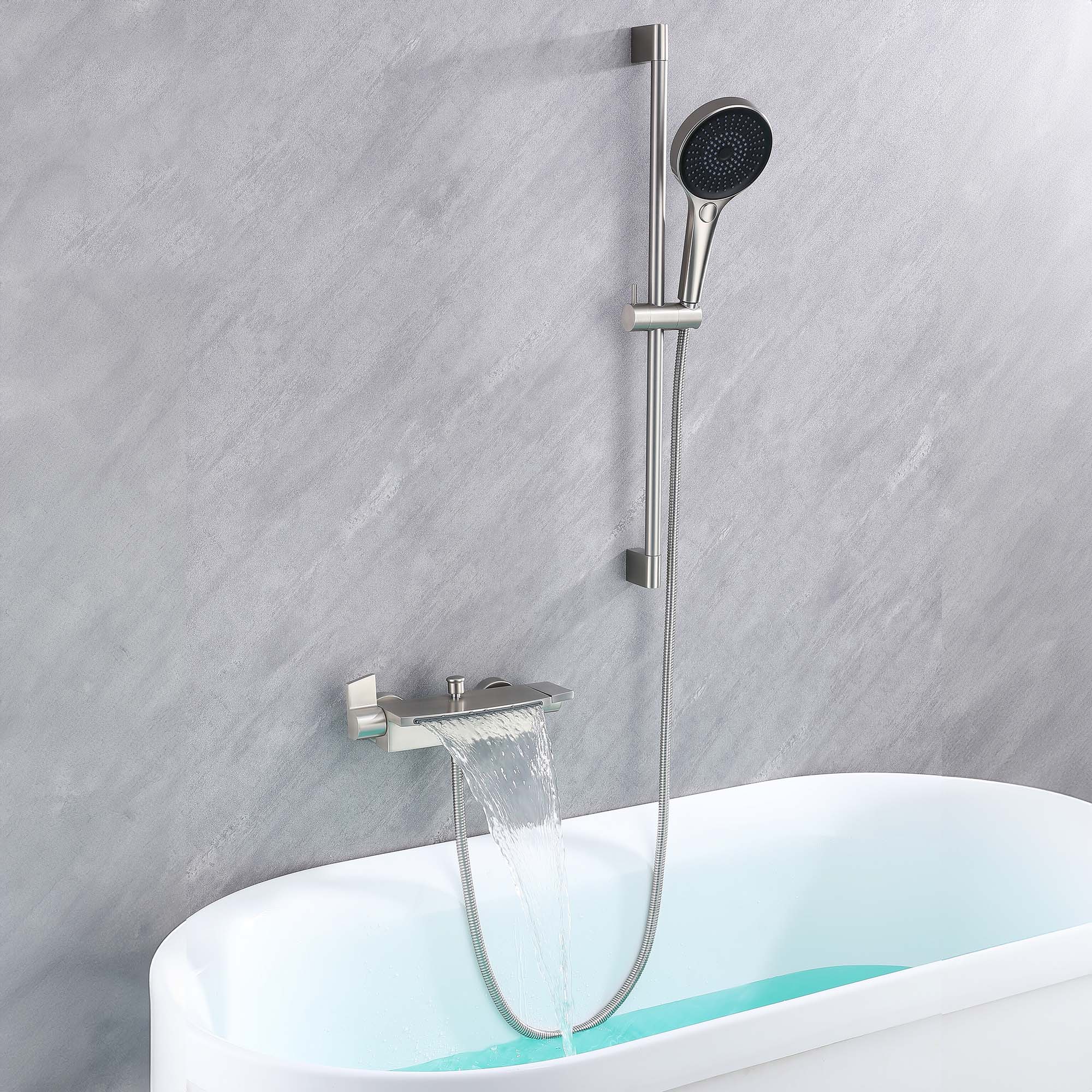 Brushed nickel Ella waterfall wall-mount faucet filling a walk-in tub, with the hand shower resting on its 24 inch slide bar