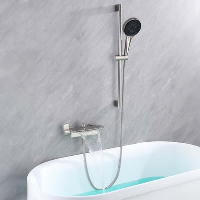 Brushed nickel waterfall tub faucet filling a walk-in tub with handheld showerhead on adjustable slide bar