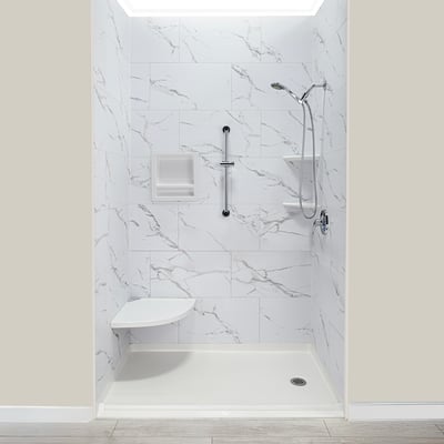 Ella accessible shower stall with marble-look walls, corner fold-down seat, grab bar, and handheld showerhead