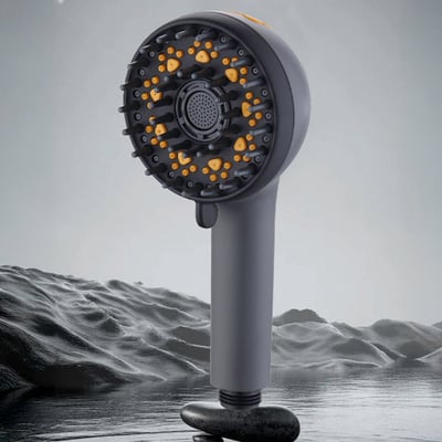 Close-up of a matte black handheld showerhead with yellow massage nozzles and multi-spray settings for accessible bathing