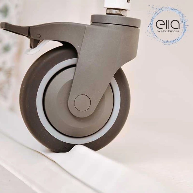 Shower chair caster rolling over the Ella collapsible rubber dam on a barrier-free shower base