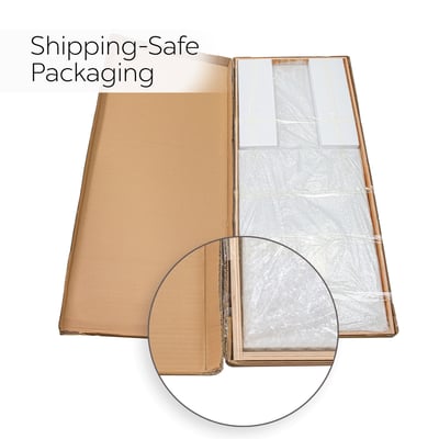 Open cardboard box revealing Ella shower wall panels wrapped in bubble wrap and foam padding for shipping-safe delivery