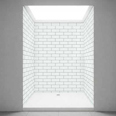 Walk-in shower stall interior with white subway tile walls and a clean flat shower base with center drain
