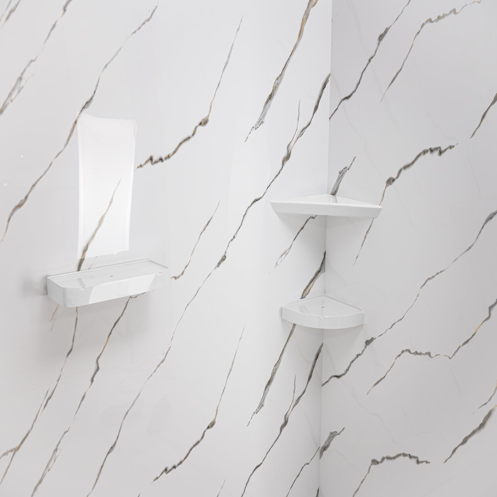 White acrylic soap dish and two corner shelves mounted on Calacatta Gold marble-look shower wall panels