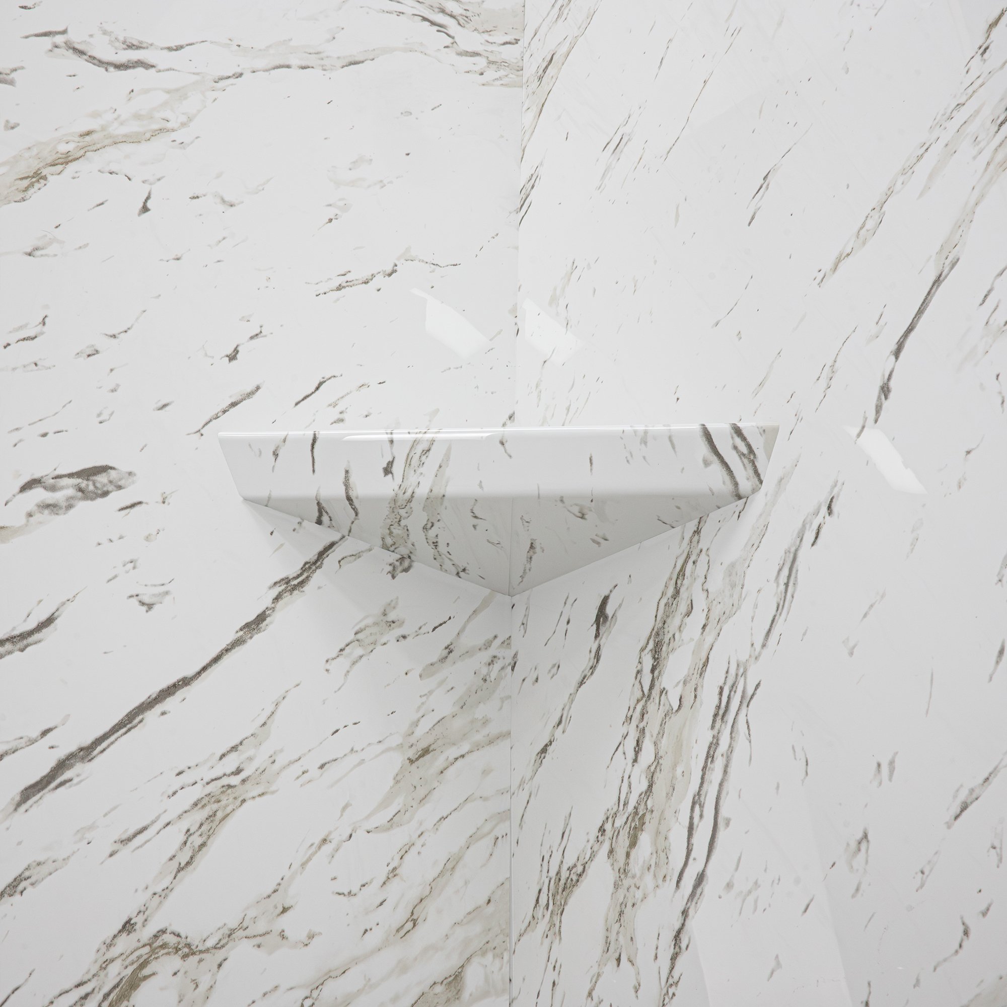 Close-up of a pattern-matched corner shower shelf in Heritage Calacatta marble-look wall panels inside an accessible shower stall