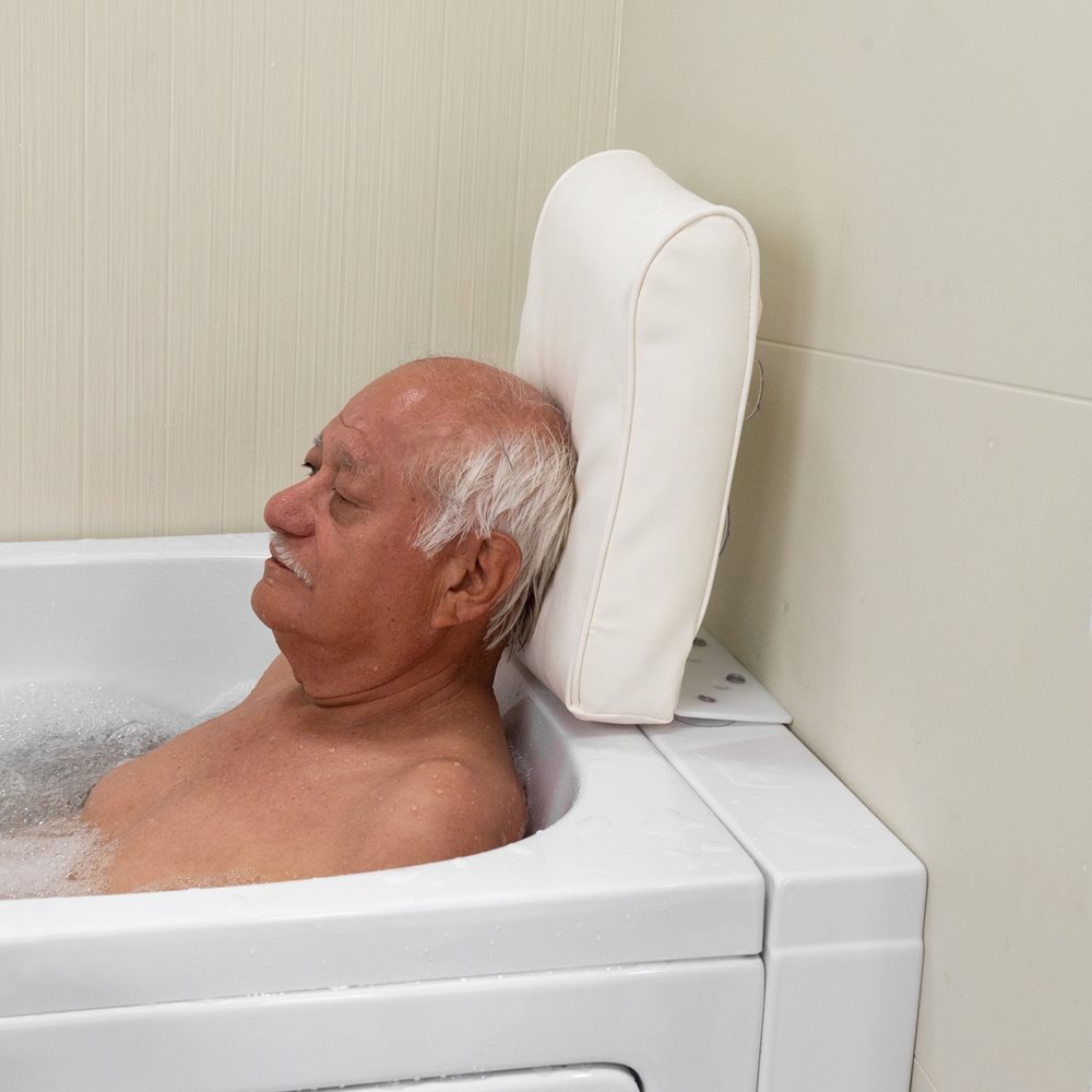 Senior man relaxing with eyes closed in a bubbling Ella walk-in tub resting his head on a padded white neck pillow