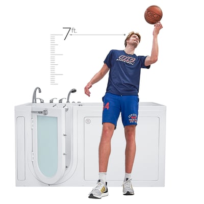 Tall basketball player spinning an Ella's Bubbles branded ball beside a large walk-in tub with outswing door, showing 7ft height scale