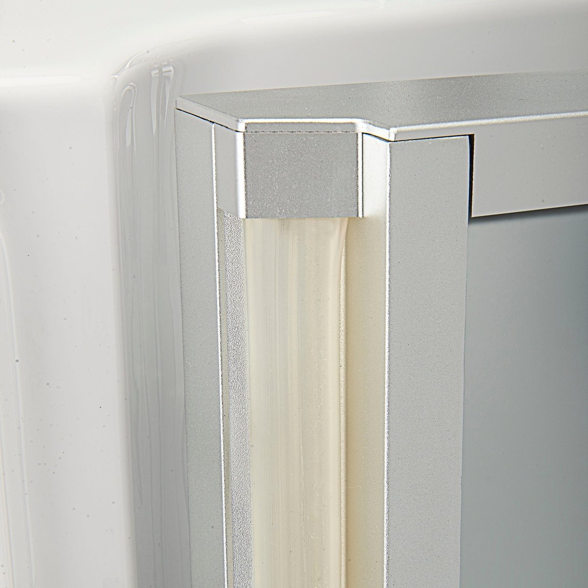 Gros plan sur le joint de porte étanche et l'angle du cadre en aluminium d'une baignoire à porte Ella Ultra