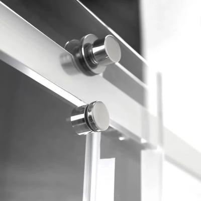 Close-up of chrome hardware rollers on an 8mm tempered glass sliding shower door panel track system