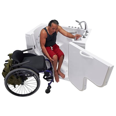 Wheelchair user transferring from wheelchair into the Ella Transfer60 walk-in tub with outward swing door open beside him