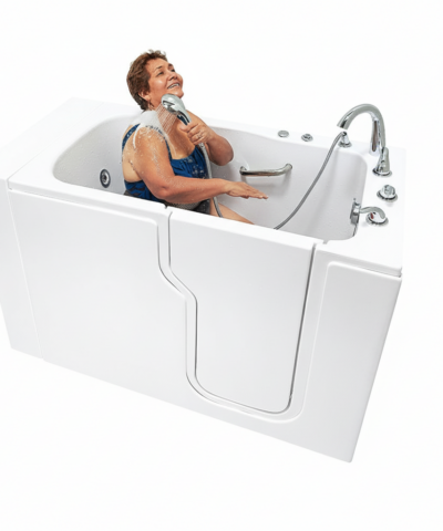 Senior woman laughing joyfully while using a handheld showerhead inside the Ella Standard 30x52 walk-in tub with side door entry
