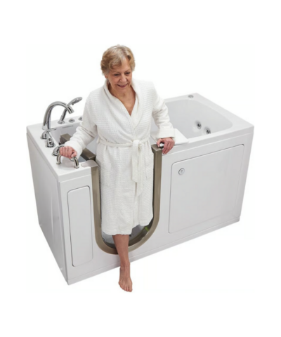 Senior woman stepping into an Ella Ultimate 30x60 walk in tub through the open left-hand door with grab bar support