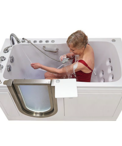 Woman using the handheld shower while seated in an Ella Ultimate walk in bathtub with wall mounted hydrotherapy jets