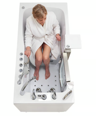 Senior woman seated in the Ella Ultimate 30x60 walk in tub, showing the wide contoured seat and open door entry