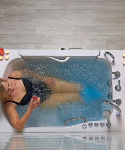 Woman relaxing in the Ella TransferXXL walk-in tub with air massage therapy