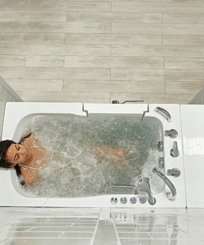 Woman relaxing in the bubbling hydro massage water of a Capri walk in tub