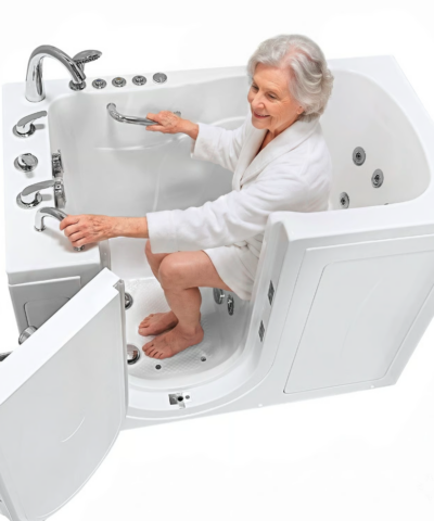 Senior woman seated inside the Capri walk in tub holding the deck mounted grab bar