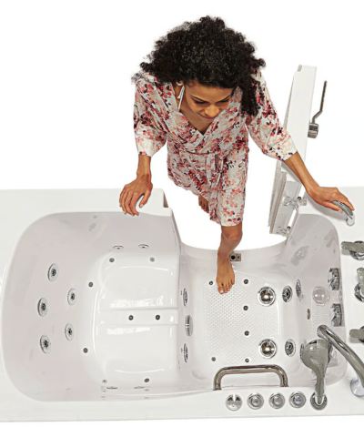 Woman stepping into the Capri walk in bathtub through its wide open outward swing door