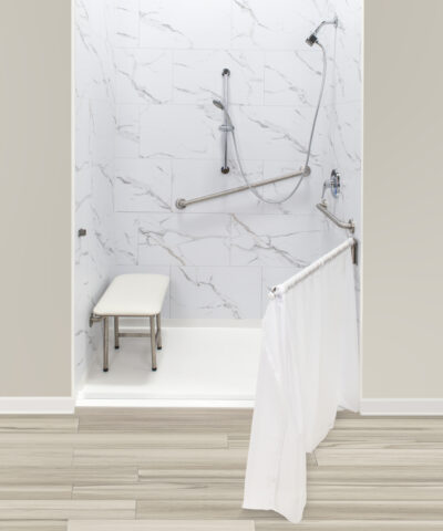 Barrier-free accessible shower with marble walls, stainless grab bars, handheld showerhead and fold-up bench